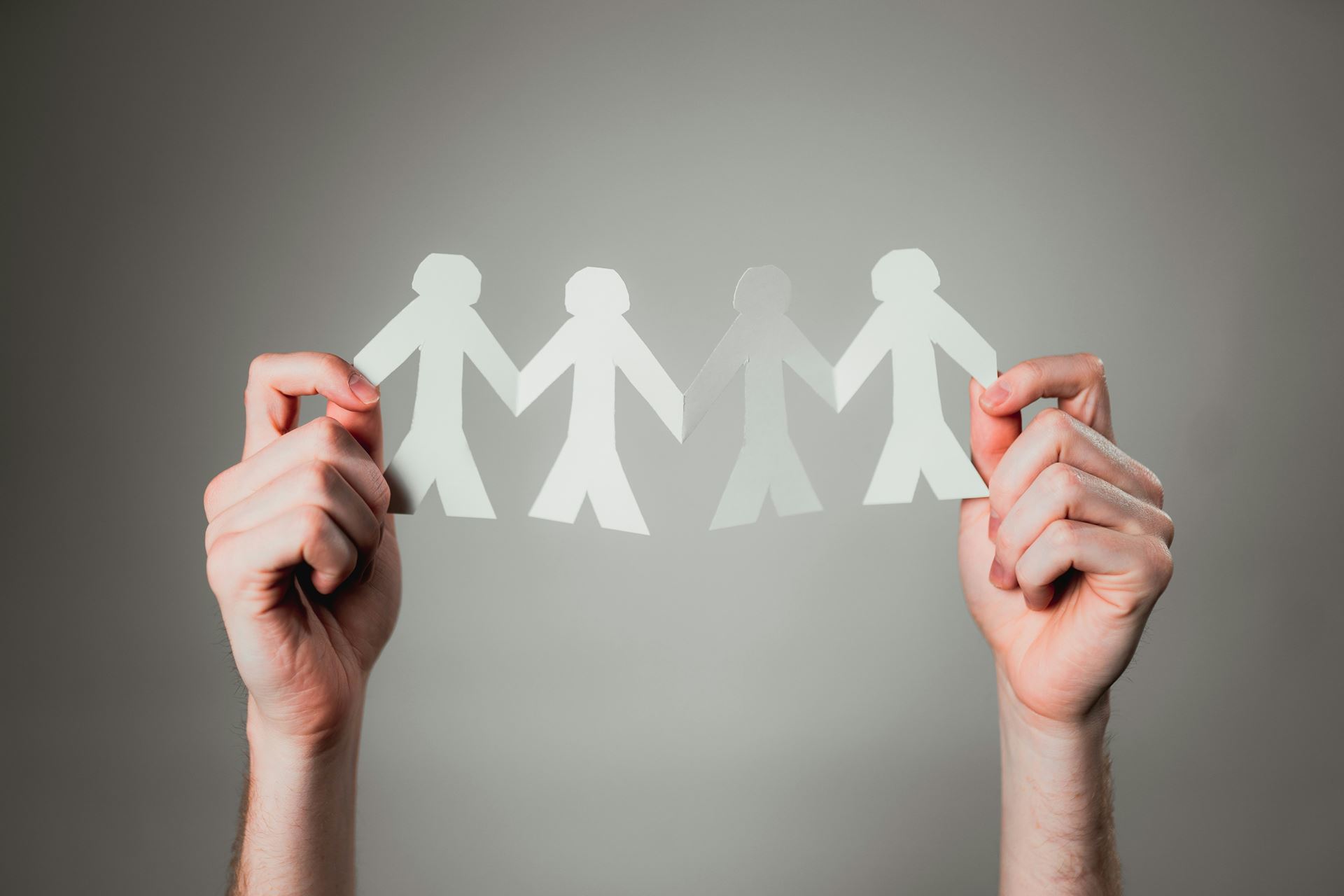 Paper people holding hands